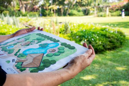 Photo of a person holding landscape plans